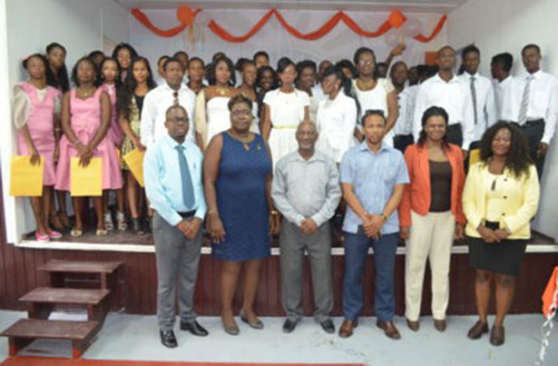 (From left to right)- BIT Technical Officer, Richard Maughn; Assistant Director, National Community Development Council (NCDC), Sandra Adams; Minister within the Ministry of Social Protection, Keith Scott; Region 10  Member of Parliament, Jermaine Figueira; Assistant Director of Youth, Leslyn Boyce, along with the 69 graduates of the BIT Youth Empowerment training project
