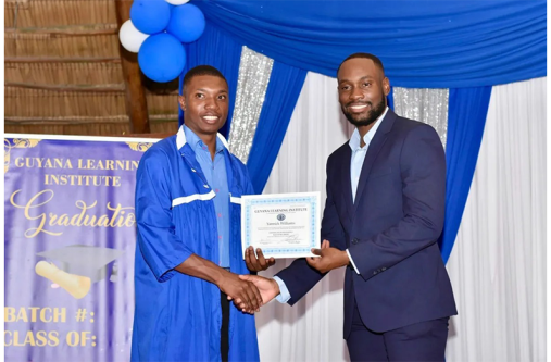 Minister of Labour and Manpower Planning Keoma Griffith hands over a certificate to a graduate (DPI photos)