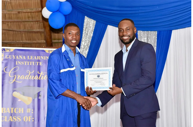 Minister of Labour and Manpower Planning Keoma Griffith hands over a certificate to a graduate (DPI photos)