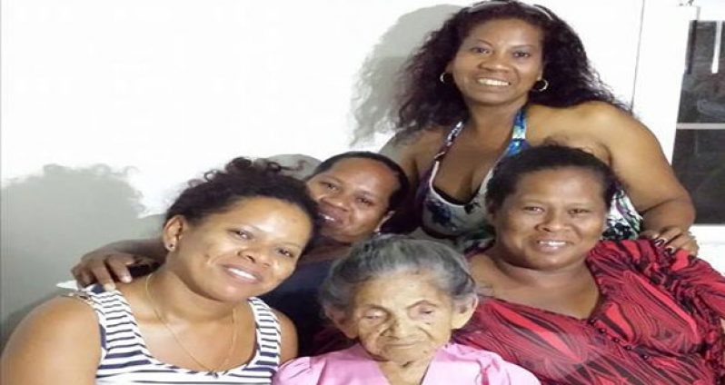 Mama Bibiana Hernandez surrounded by her granddaughters on a recent visit to the city of Georgetown