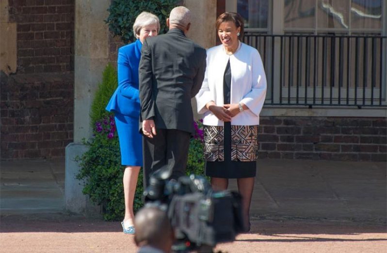 President David Granger greets UK Prime Minister Theresa May, in the presence of Commonwealth Secretary-General, Baroness, Patricia Scotland