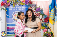 Faith Henry receives her grant from Human Services Minister, Dr Vindhya Persaud