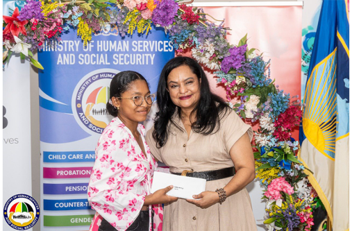 Faith Henry receives her grant from Human Services Minister, Dr Vindhya Persaud