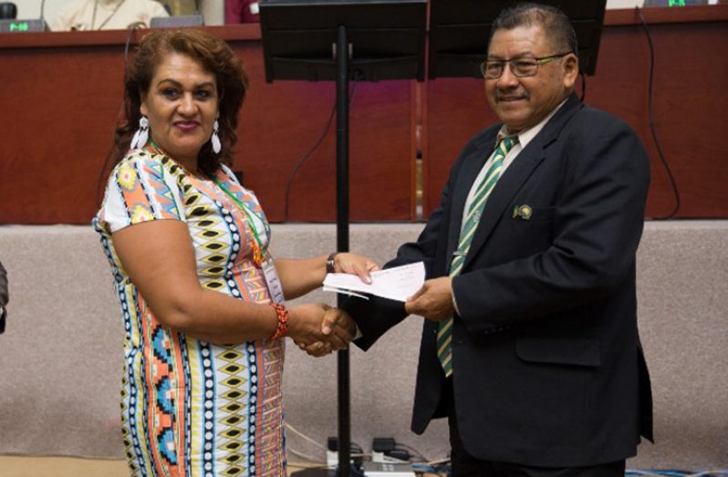Toshao of Santa Rosa, Whanita Phillips receiving a cheque from Minister of Indigenous Peoples’ Affairs, Hon. Sydney Allicock