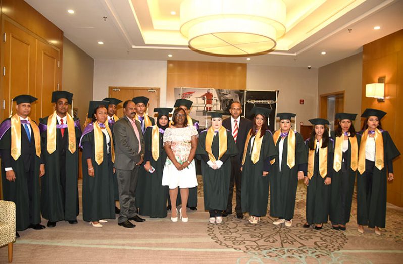 Minister within the Ministry of Public Health, Dr. Karen Cummings and Opposition MP, Dr. Frank Anthony, stand with Greenheart’s executive director Dr. Tom Yesudas and the graduating class of 2017 (Adrian Narine photo)