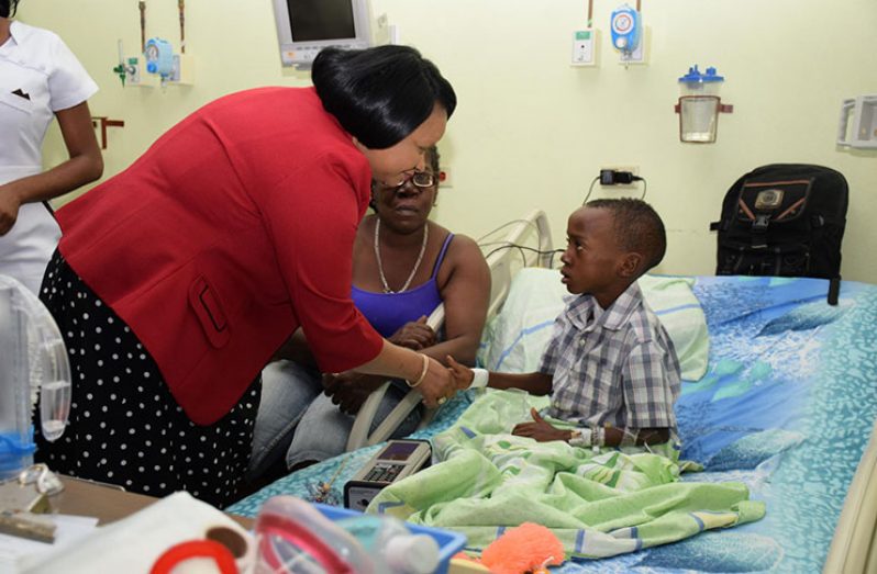 Health Minister Volda Lawrence greets a patient of the Paediatric Ward of the Georgetown Public Hospital Corporation (GPHC photo)