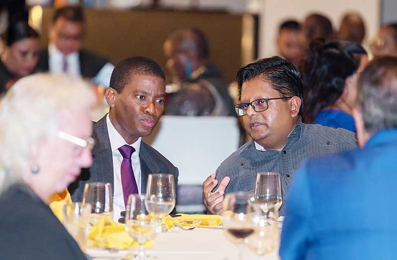 Senior Minister in the Office of the President with responsibility for Finance and the Public Service, Dr. Ashni Singh (right), and Prime Minister of Grenada Dickon Mitchell (left), during the welcome reception on Wednesday (Delano Williams photo)