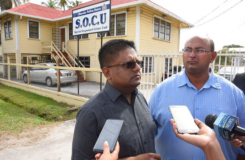 Dr. Ashni Singh and Winston Brassington speak with the media Wednesday after being released on $200,000 station bail each (Samuel Maughn)