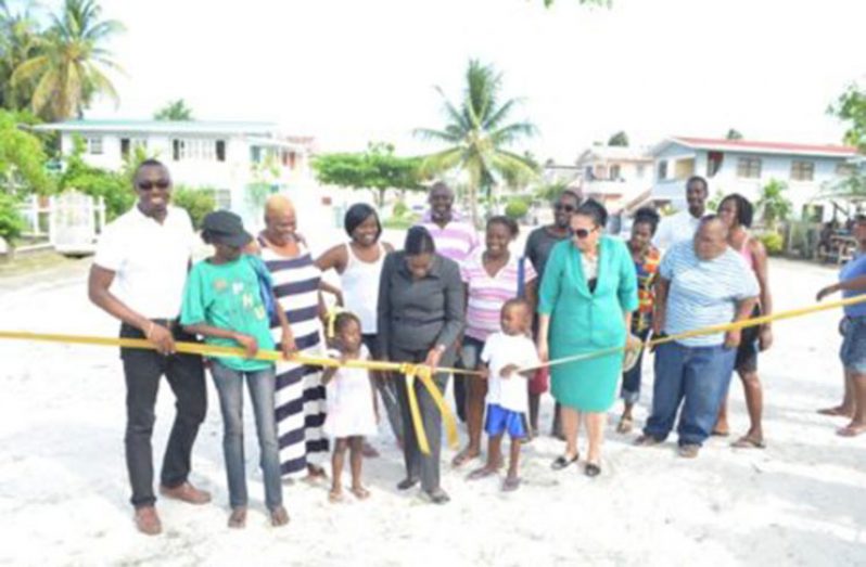 Minister within the Ministry of Education, Nicolette Henry, with residents during the ribbon-cutting ceremony at the Guyhoc Square area
