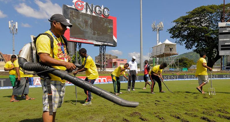 Ground staff at Queen's Park Oval dug up the outfield in a bid to get it to dry out. (AFP)