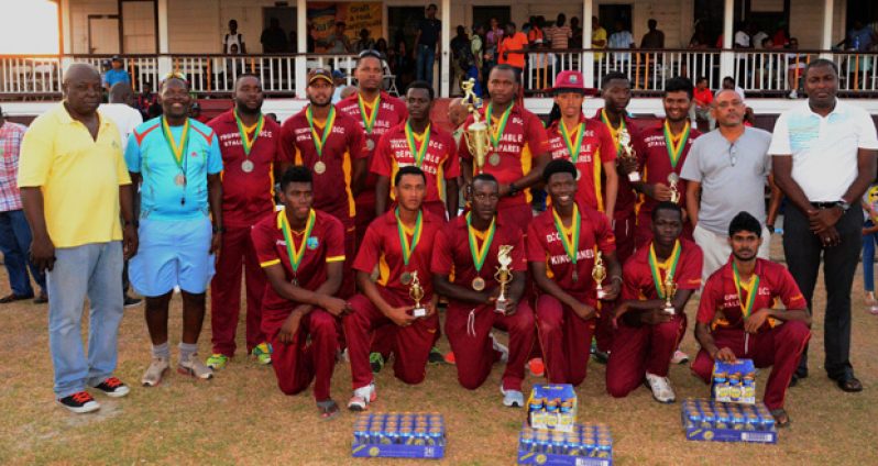 The 2015 Carib Beer T20 Champions, Demerara Cricket Club (DCC), pose with their accolades after sinking GCC in the final yesterday at the DCC Ground. (Adrian Narine Photo)