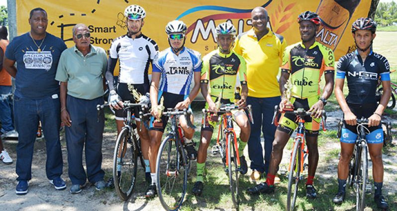 From left: Mortimer Stewart and  Hassan Mohamed pose with the respective winners in the National Park.