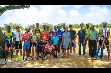 Prize winners of the various categories of the Universal Auto and General Supplies cycle race strike a pose for photographer Delano Williams. At centre is Mrs. Rohini Baksh, wife of the sponsor and veteran cyclist,Shameer Baksh.