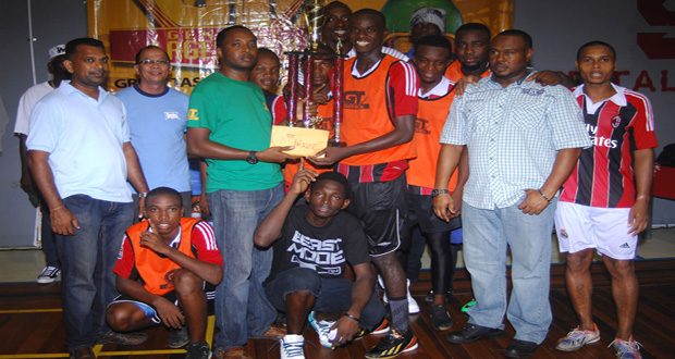 The first-ever GT Beer Futsal champions Bent Street receive the top prize from GT Beer brand manager Jeff Clement. (Samuel Maughn photos)