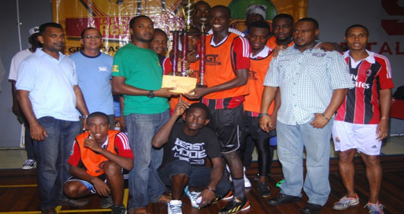 The first-ever GT Beer Futsal champions Bent Street receive the top prize from GT Beer brand manager Jeff Clement. (Samuel Maughn photos)