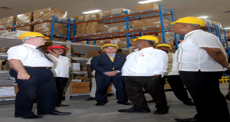 From left, USAID-SCMS consultant Richard Miller; Health Minister Dr Bheri Ramsaran; U.S. Ambassador D. Brent Hardt; Prime Minister Sam Hinds; and Minister in the Ministry of Finance, Juan Edghill, tour the new warehouse.