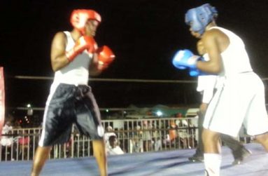 Forgotten Youth Foundation’s Stefan Smith (black trunks) keeps his guard up and eyes focused on an attacking Akiel Mounter of Essequibo, during their clash last Friday night.