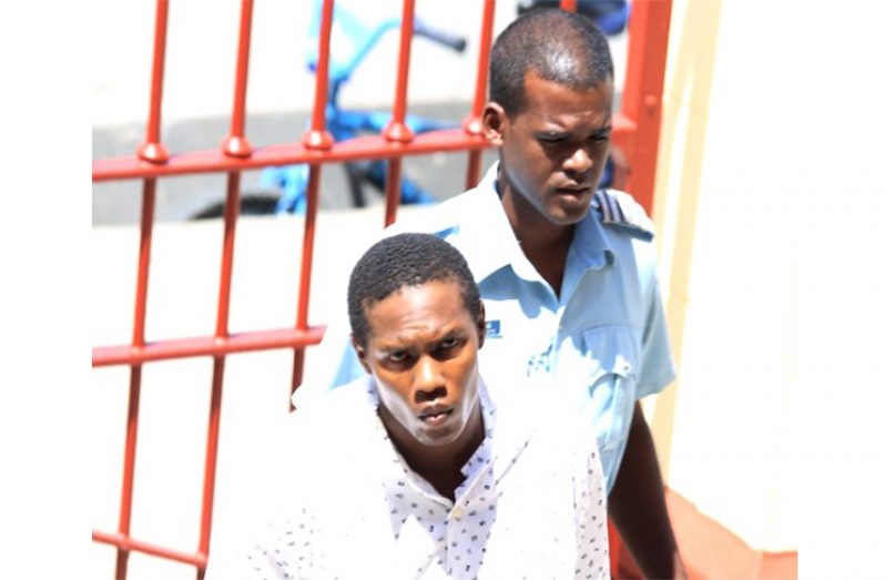 Rondel Mitchell (left) as he was escorted to court by the police.
