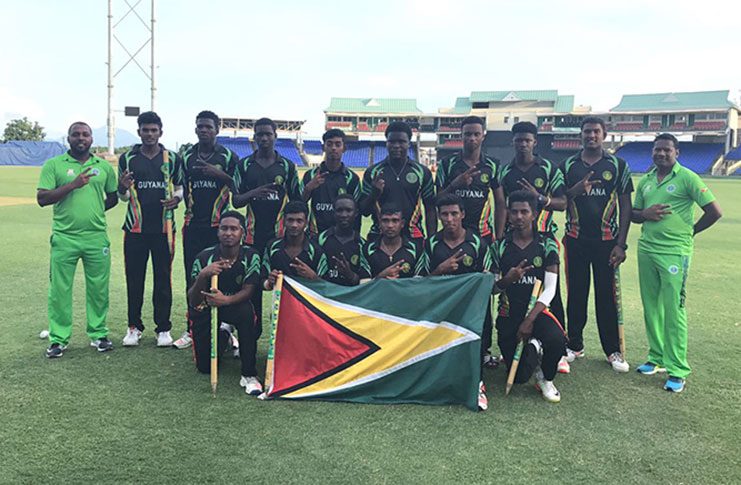 The jubilant Guyana Under-19 cricketers celebrate with the Golden Arrowhead after completing the double in St Kitts.