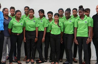Female U-19 Guyana team flanked by Colin Stuart (left) and coach sponsor Wayne James.