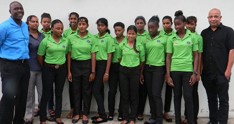 Female U-19 Guyana team flanked by Colin Stuart (left) and coach sponsor Wayne James.