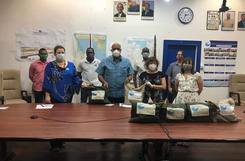 GWI, UNICEF and Canadian High Commission officials pose for a photo opportunity with the care packages that will be distributed.