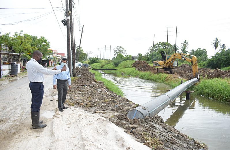 GWI’s CEO, Shaik Baksh (right) and GWI’s Director of Projects, Aubrey Roberts, observe ongoing works to replace a section of pipeline at Kitty