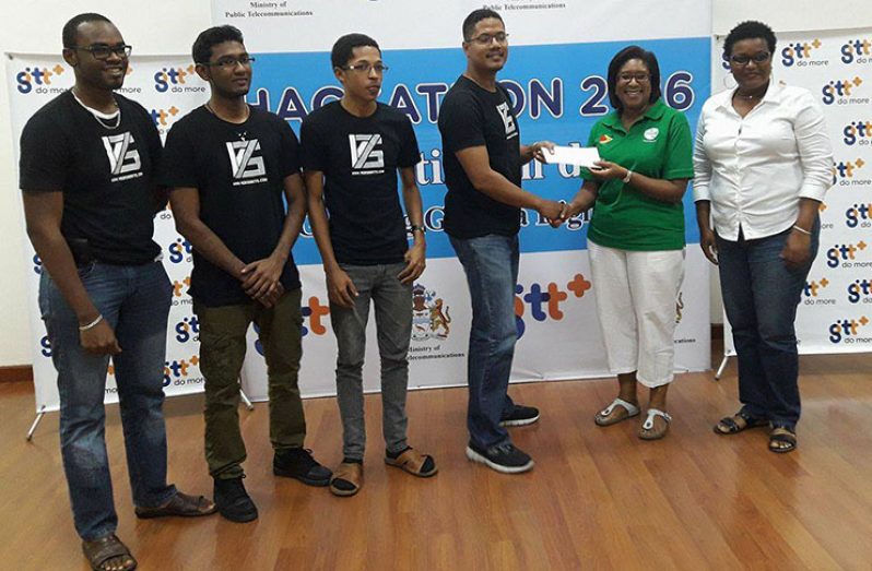 The winning team, ‘V75’, collects their prize from Minister of Public Telecommunications, Ms Cathy Hughes. At right is GT&T Public Relations Officer, Ms Allison Parker