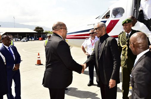 President Granger is greeted at Haiti’s airport by Minister of Foreign Affairs of Haiti, Mr Pierrot Delienne (MOTP photo)