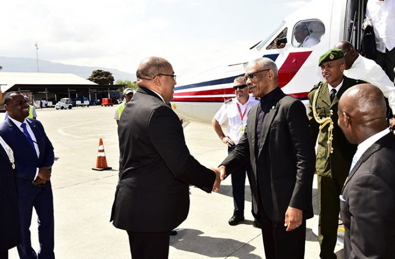 President Granger is greeted at Haiti’s airport by Minister of Foreign Affairs of Haiti, Mr Pierrot Delienne (MOTP photo)