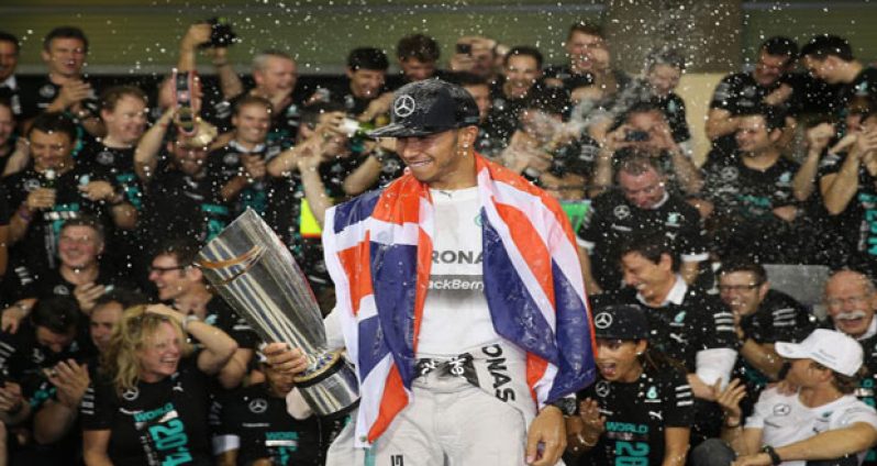 ABU DHABI, UNITED ARAB EMIRATES - NOVEMBER 23: Lewis Hamilton of Great Britain and Mercedes GP celebrates with his team after winning the World Championship after the Abu Dhabi Formula One Grand Prix at Yas Marina Circuit, yesterday. (Photo by Clive Mason/Getty Image