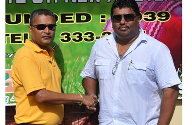 Let’s put our hands together and work to get the job done. Newly elected president of the Berbice Cricket, Board Anil Beharry (right), and secretary of the Guyana Cricket Board, Anil Sanasie, exchange pleasantries in front of the BCB office last Sunday.