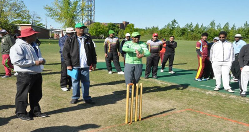 10/10 sponsor Harri Sukhu (in green top) delivers the first ball to kick off the tournament. On his right are OSCL president Albert Ramcharran and treasurer Vish Jadunauth.