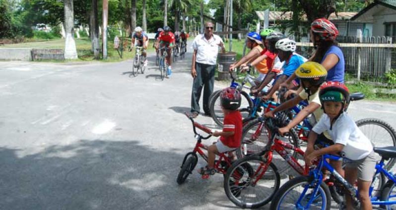National cycle coach Hassan Mohamed (standing) is caught by photographer Cullen Bess-Nelson explaining the basics of the art of riding to the newcomers while at left, seasoned cyclists are seen putting mileage in their legs.