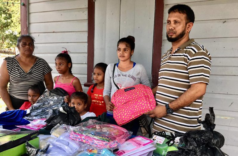 Public Relations Officer of the Humanitarian Mission Guyana Inc, Mahendra Dass Nandlall, hands over the items to the family 