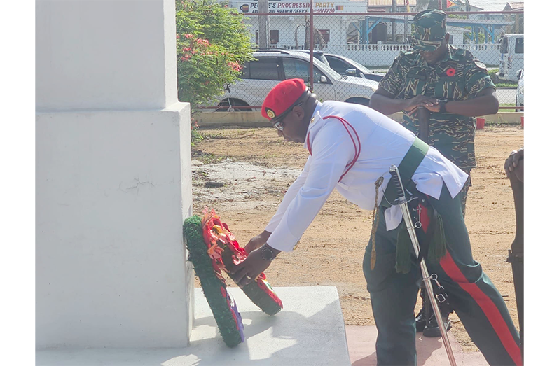 A member of the Guyana Defence Force lays the ceremonial wreath in honour of the fallen heroes