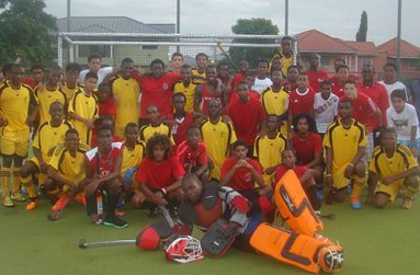 Guyana’s National Junior Men’s team in gold and the T&T Development U-19s after the game on Wednesday
