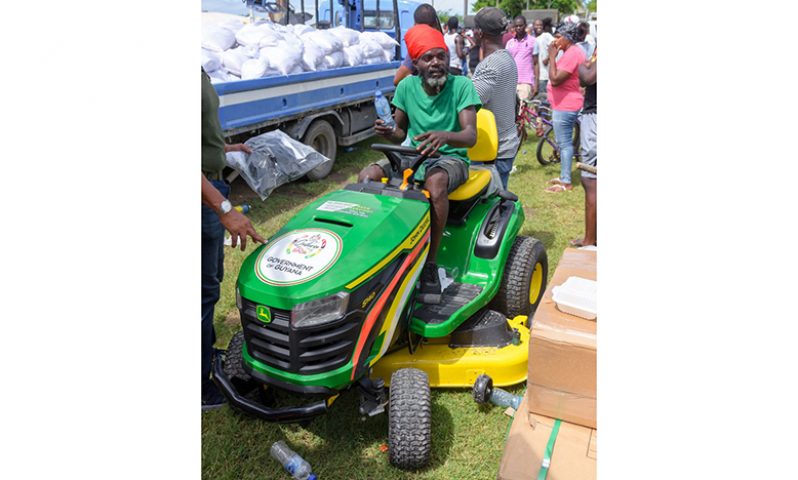 A resident tests out the new lawn mower