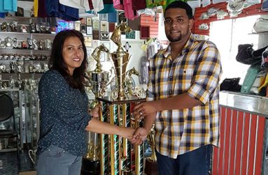 Devi Sunich, wife of Trophy Stall owner, hands over a trophy to Nasurdeen Mohammed of Jumbo Jet.