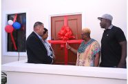 One of the beneficiaries of the Housing Ministry’s Adequate Housing and Urban Accessibility Programme cutting the ribbon to her new house. Pictured are Minister of Housing, Hon. Collin Croal and Minister within the Ministry, Hon. Vanessa Benn