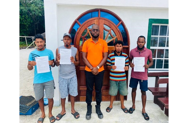 A FFTP official (centre) and some of those who will be receiving new homes in the coming months