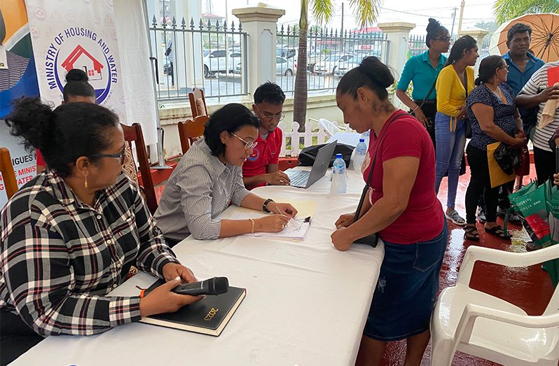 Minister Susan Rodrigues documents a complaint during the outreach. Pictured to her left is Region Two Chairperson Vilma De Silva