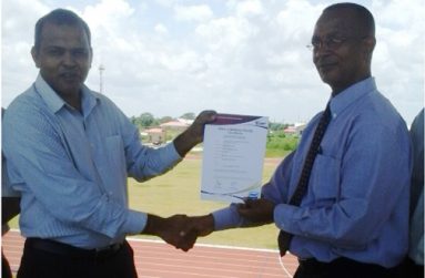 Minister of Culture, Youth and Sport, Dr Frank Anthony and president of the Athletics Association of Guyana (AAG) Aubrey Hudson hold the IAAF certificate.