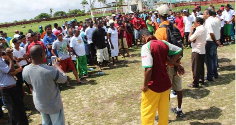 Some of the hundreds who turned out last Sunday at Anna Regina are being addressed by Minister Anthony.