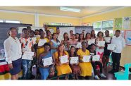 Minister of Natural Resources, Vickram Bharrat (centre at rear), flanked by graduates of the recent ICT training in Region Six