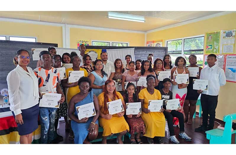 Minister of Natural Resources, Vickram Bharrat (centre at rear), flanked by graduates of the recent ICT training in Region Six