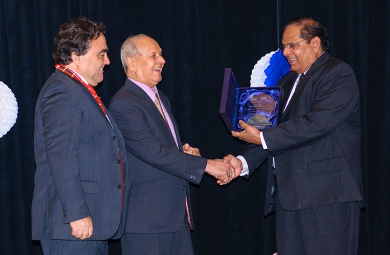Dr. Yesu Persaud being presented with an award by Prime Minister Moses Nagamootoo (Delano Williams photo)