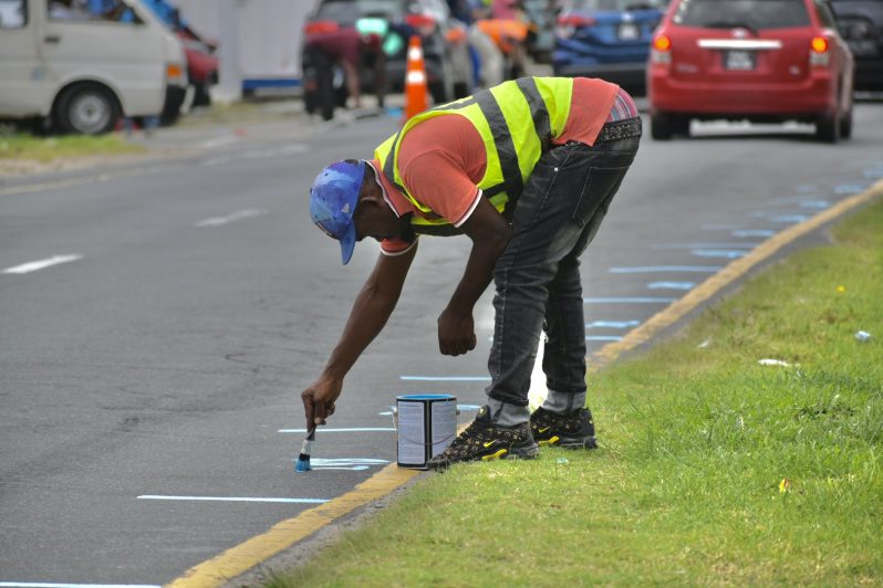 City workers mark designated vending spots along Vlissengen Road, as the Mayor and City Council ramps up early preparations for Mashramani 2026. 

(Sachin Persaud)