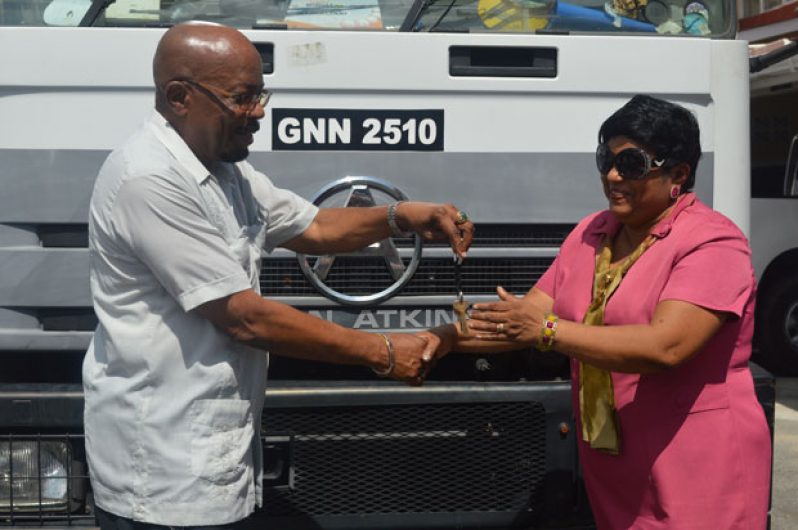 Local Government Minister Norman Whittaker hands over the keys to the truck to Acting Town Clerk, Ms  Carol Sooba