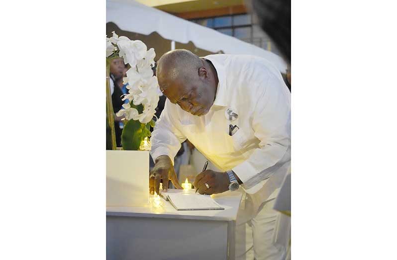 PM Phillips signs the book of remembrance for MV Barima tragedy victims